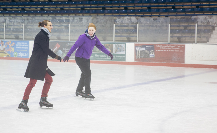 Two individuals enjoy ice skating at Penn Ice Rink