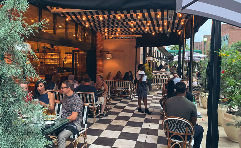 diners eating on a covered patio