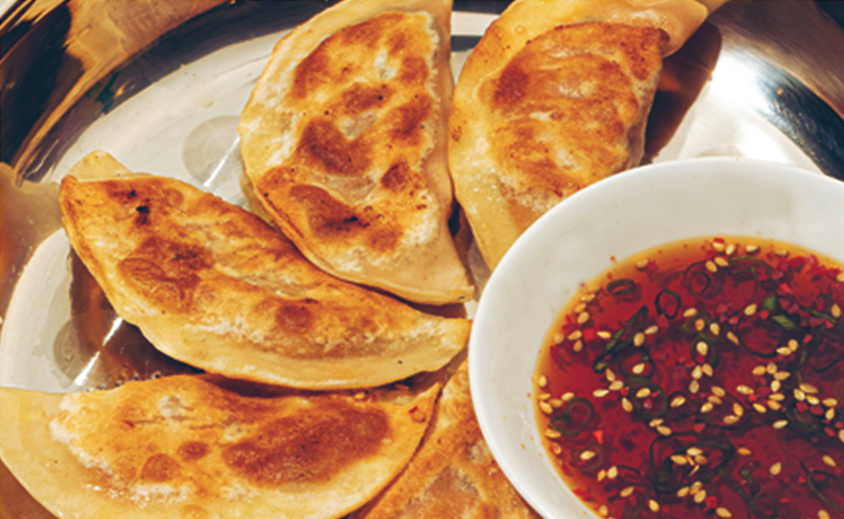 korean dumplings with sauce on a dish