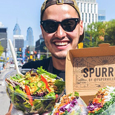 Alex Sherack Front man outside holding food