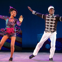 December Playlist Front dancers in holiday costumes performing on stage