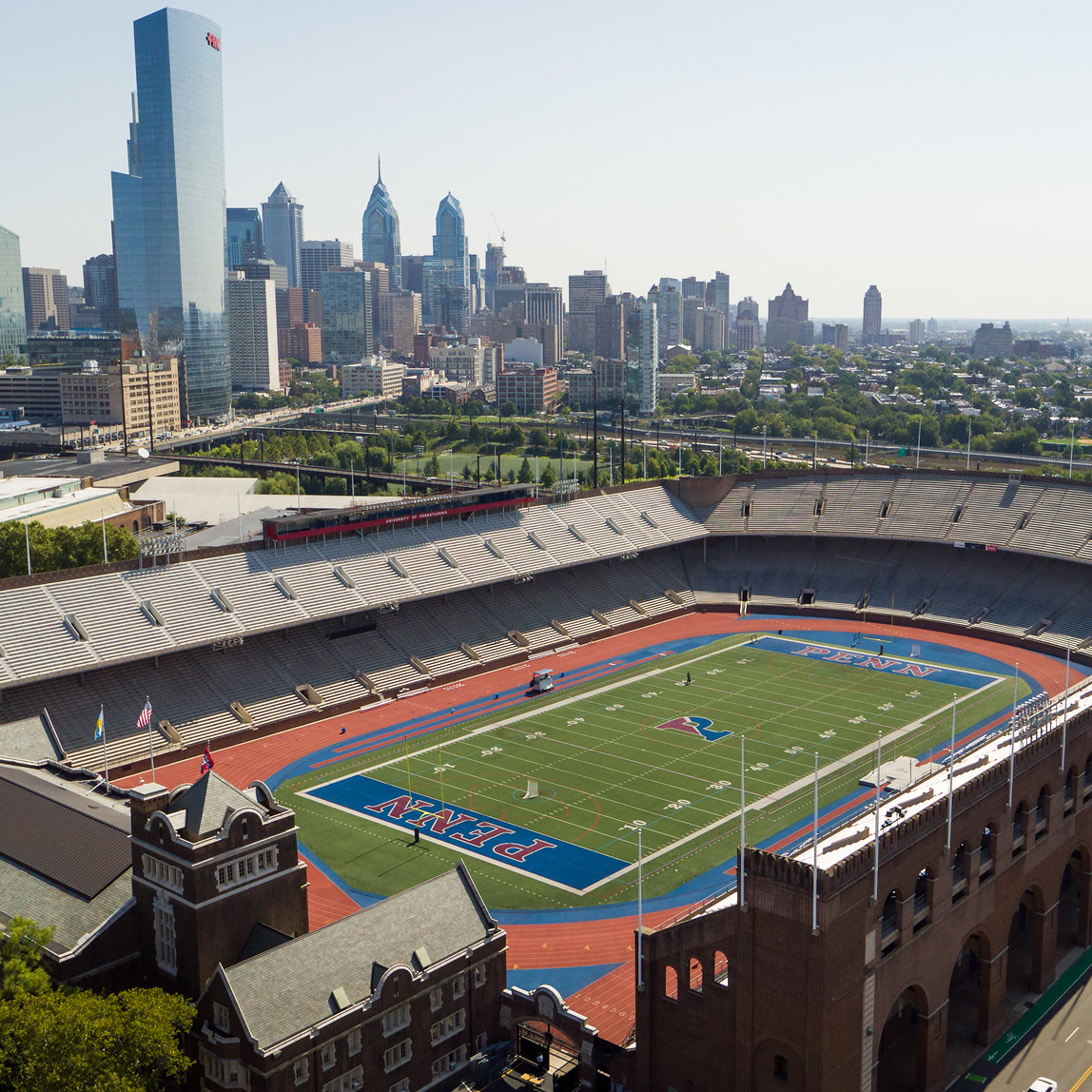 overhead view of football stadium with a city skyline in the background