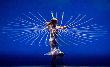 woman dancing in front of blue background