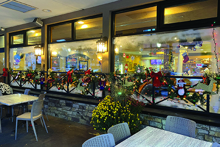 Holiday window with garland drapped across wood