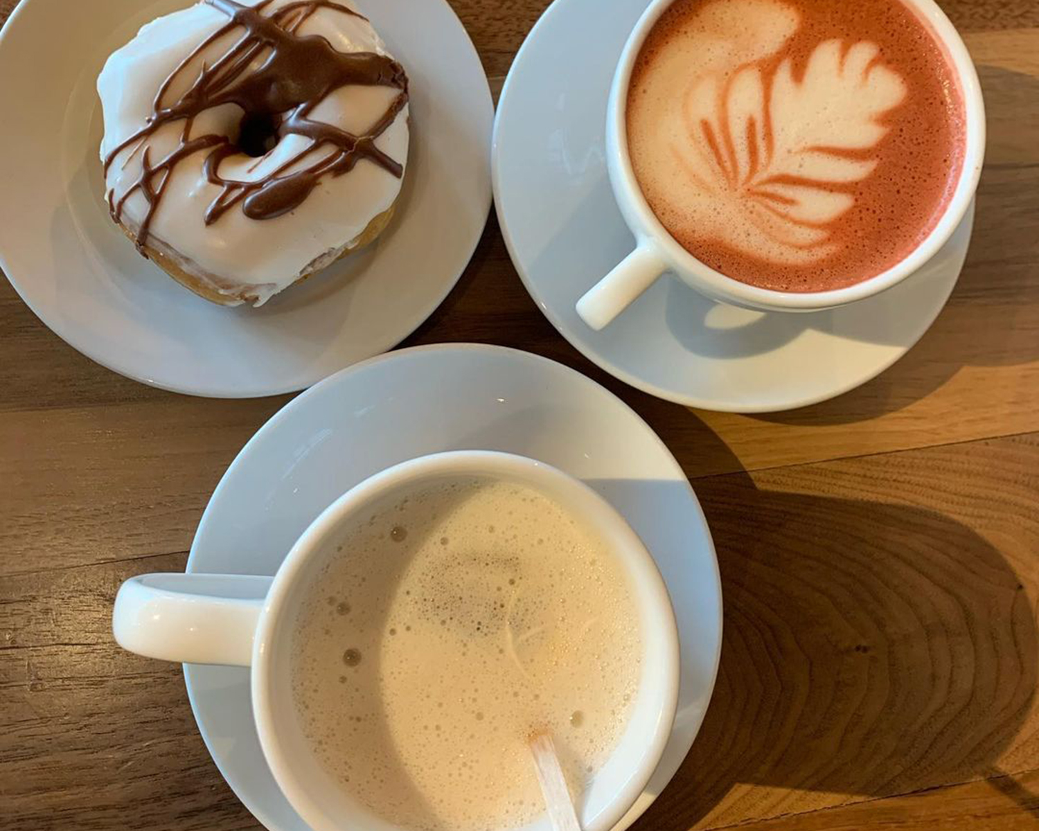 hot beverages and a donut on a table