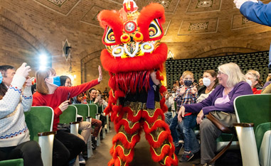 chinese dragon walking down aisle in audatorium