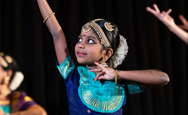 young indian girl perfoming a holi dance