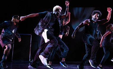 men dressed in all black performing dance routine