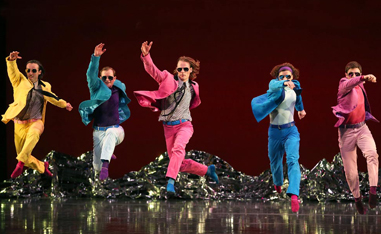 men in colorful suits dancing