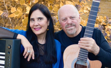 man and woman sitting with instruments