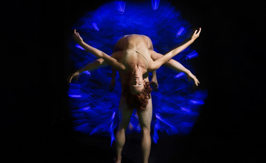 two dancers in front of black and blue background