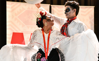 man and woman in dia de los muertos costumes with faces painted