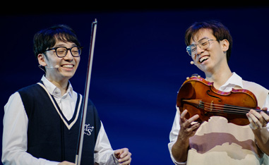 two asian men holding violins