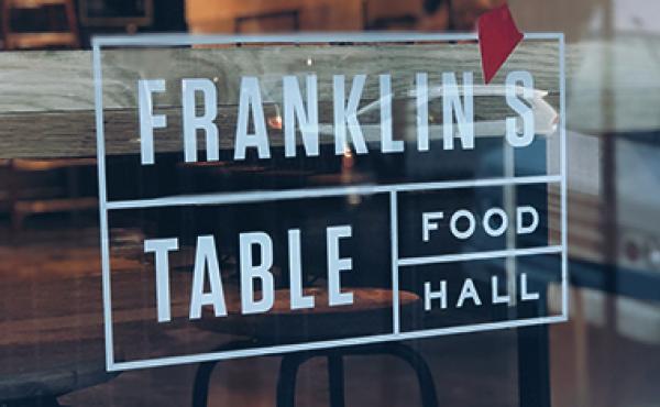 Franklin's Table logo on food hall window