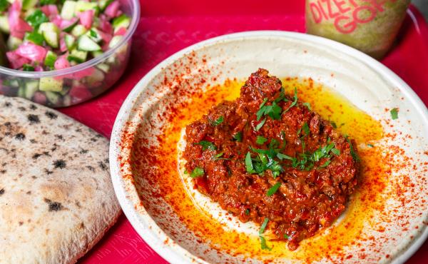 red peppers on hummus plate