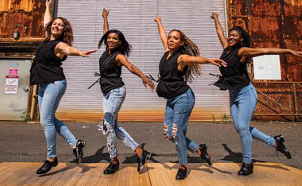 four women tap dancing outside