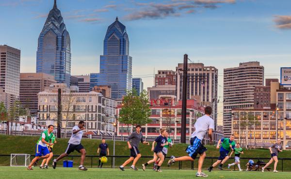 Photo of soccer players and skyline view at Penn Park 