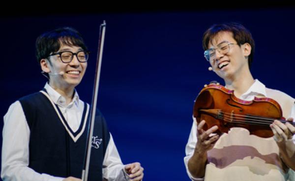 two asian men holding violins
