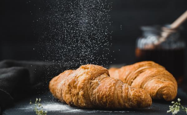 Photo of sugar being dusted onto a croissant