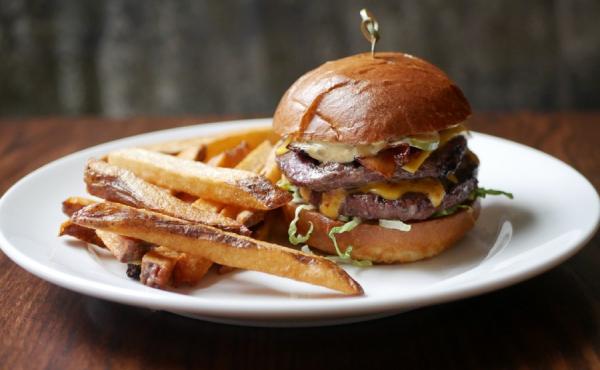 Image of a burger and fries on a restaurant plate 