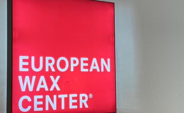 Photo of red and white sign reading European Wax 