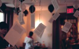 Sheets of paper hanging from the ceiling inside the Kelly Writers House.